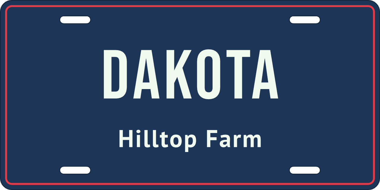 A single line: a stall sign reading Dakota, Hilltop Farm