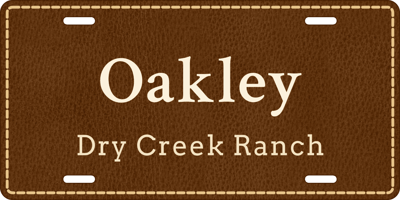 Saddle leather: a stall sign reading Oakley, Dry Creek Ranch