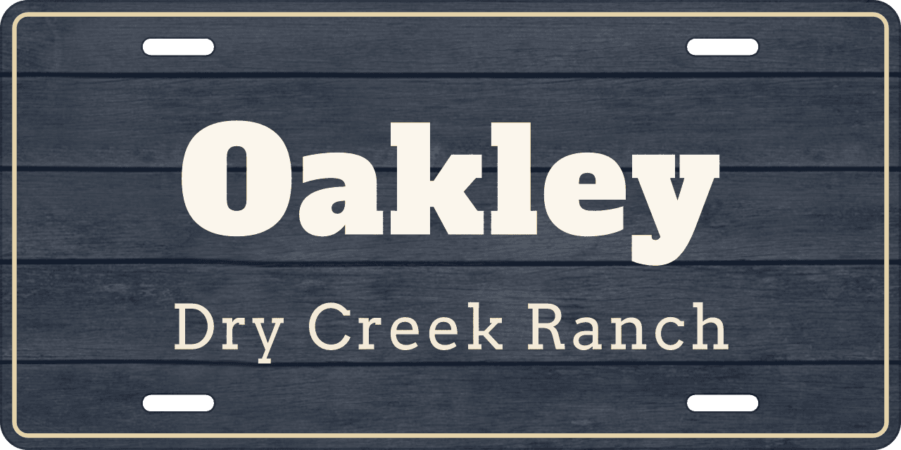 Barnwood, tinted navy: a stall sign reading Oakley, Dry Creek Ranch