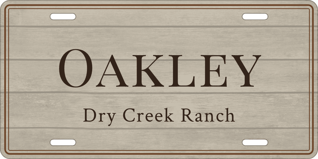 Whitewashed barnwood: a stall sign reading Oakley, Dry Creek Ranch